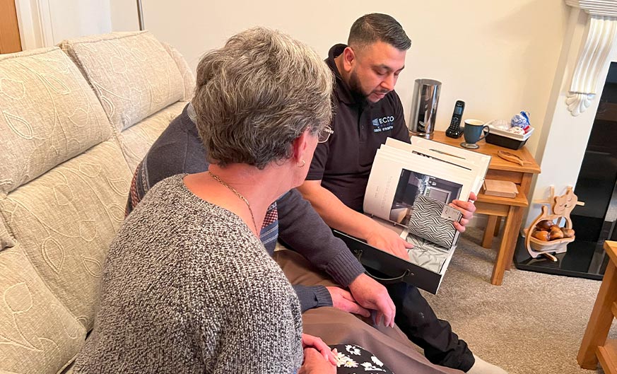 Ecco Blinds advisor presents blind samples to a customer, showcasing Our Guarantee of personalised service.